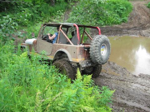 1978 Ford Bronco - This Jeep is navigating a muddy trail with a large puddle ahead.