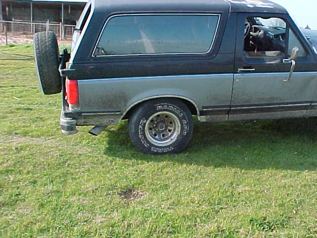 Side view of a 1991 Ford Bronco with a rear-mounted spare tire