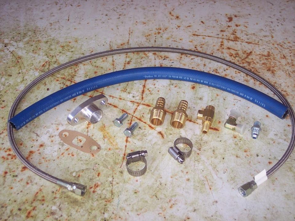 Automotive parts including a blue hose, metal flange, bolts, gasket, clamps, and brass fittings.
