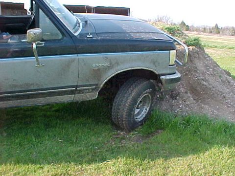 1991 Ford Bronco - This 1991 Ford Bronco is shown from the side, navigating an off-road terrain.