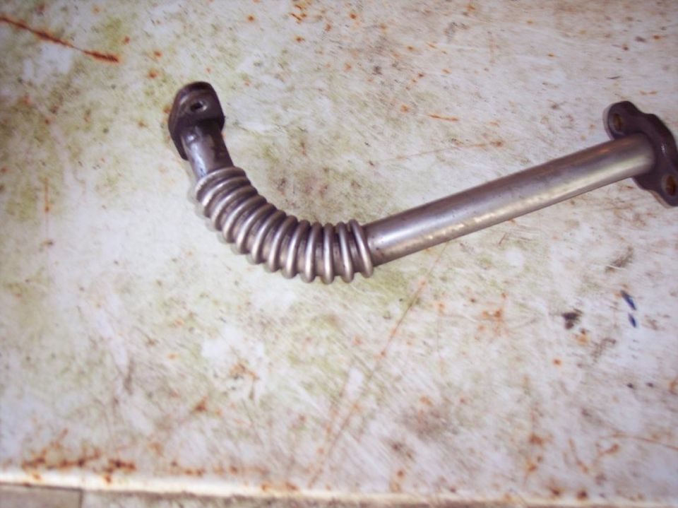 Metal exhaust pipe with corrugated section and mounting flanges.