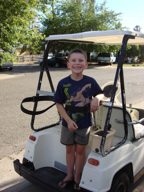 1983 Ford Bronco - here is the new golf cart with Christian on the back. we used the golf bag tie down to belt him in. he loved this.