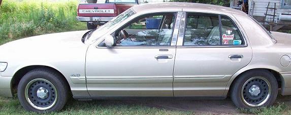 Side profile photo of a gold Mercury sedan