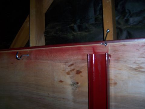 1991 Ford Bronco - Photograph of a wood and steel fabricated panel hanging from hooks on a garage wall.