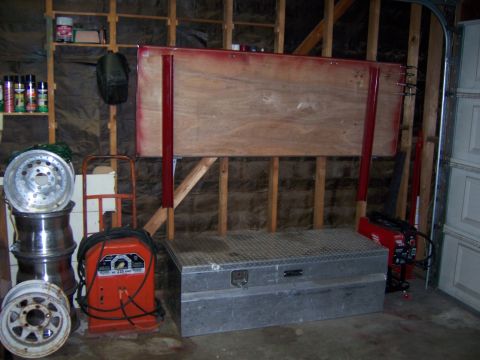 1991 Ford Bronco - Photograph of a fabricated wood-and-steel panel mounted on a garage wall above a toolbox.