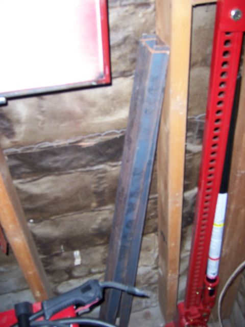 1991 Ford Bronco - Photograph of fabricated steel tubing leaning against a garage wall next to a tall jack.