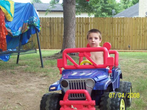 1994 Ford Bronco - A young boy sits in a toy jeep in a backyard on July 4, 2008.