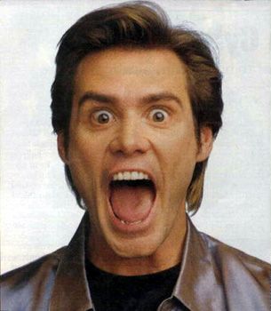 1991 Ford Crown Victoria - Jim Carrey's surprised expression is captured in this photo with 'SUPERMOTORS' text at the bottom.