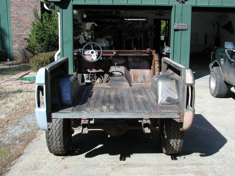 1967 Ford Bronco - Rear view of a 1967 Ford Bronco body undergoing restoration in a garage.