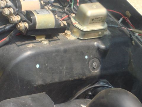 1983 Ford Bronco - I marked the spot and drilled a couple holes---making sure it was clear under the cover and do not drill the wheel.....