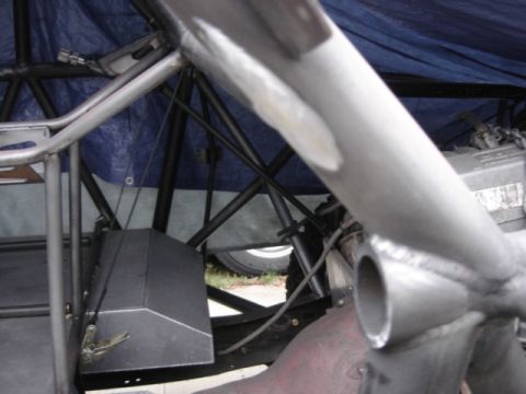 1995 Ford Bronco - Close-up view of custom roll cage and chassis components, with a tire visible in the background.