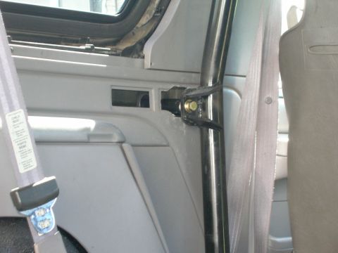 1996 Ford Bronco - Interior view of a vehicle's roll cage mounting bracket and seatbelt.