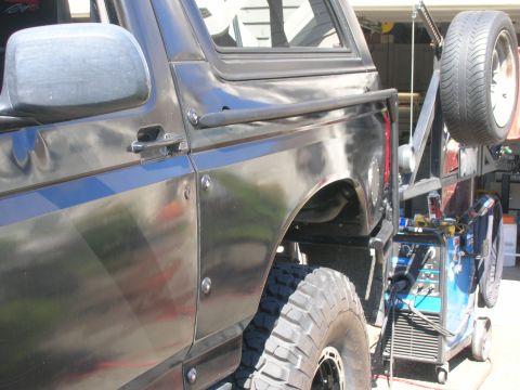 1996 Ford Bronco - This 1996 Ford Bronco is equipped with a custom spare tire carrier and welding equipment is visible nearby.