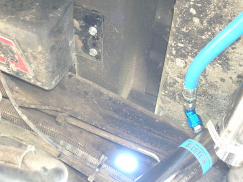 1996 Ford Bronco - Close-up of vehicle undercarriage with a blue hose and Bilstein shock absorber visible.