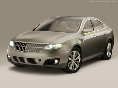1993 Ford Taurus - This silver sedan features a distinctive grille and modern LED lighting elements.
