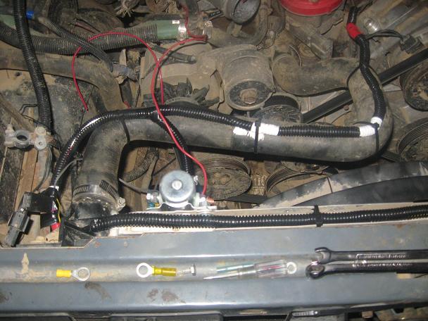 i put some split loom around the yellow wire and put it going across the top of the radiator.