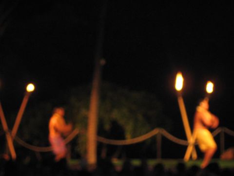 1991 Ford Bronco - A group of people perform a traditional dance with torches illuminated against a dark background.