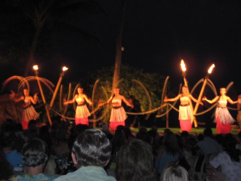 1991 Ford Bronco - A group of hula dancers entertain an audience with fire torches during a nighttime performance.