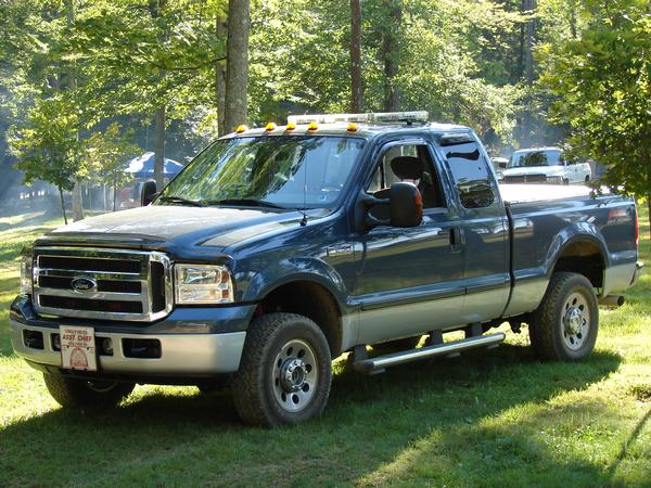 Blue Ford F-250 Super Duty extended cab pickup with roof light bar