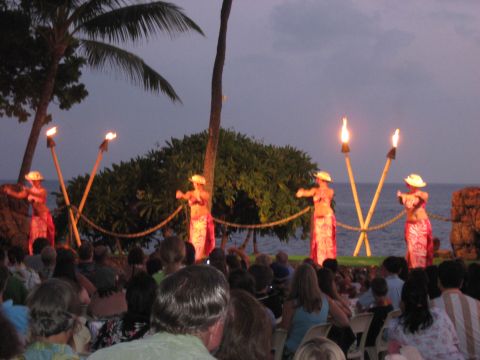 1991 Ford Bronco - Hula dancers perform with torches at dusk in front of an audience and the ocean.
