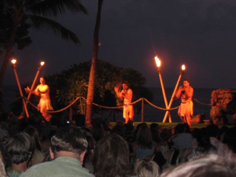 1991 Ford Bronco - Luau performance at night with torches and palm trees, with an audience watching.