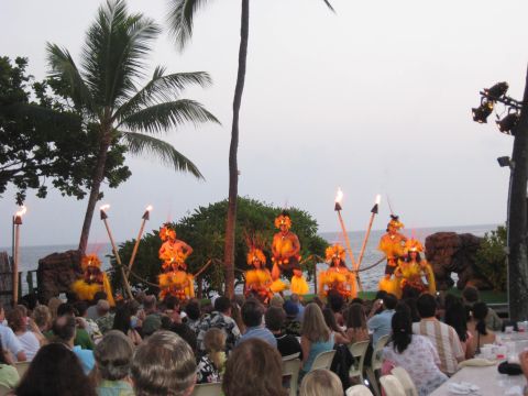 1991 Ford Bronco - A luau performance takes place on a beach with dancers, torches, and palm trees, as an audience watches.