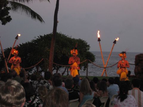 1991 Ford Bronco - A luau performance unfolds by the sea as dancers entertain a crowd under a dusky sky.