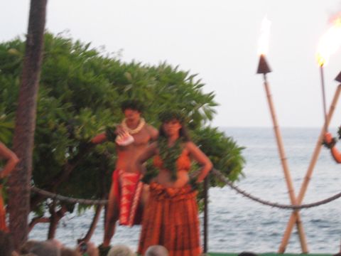 1991 Ford Bronco - A cultural performance unfolds with dancers and flaming torches against a backdrop of the sea and lush greenery.
