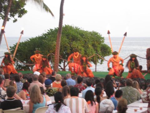 1991 Ford Bronco - A luau performance unfolds by the ocean, with dancers in traditional dress entertaining a seated audience.