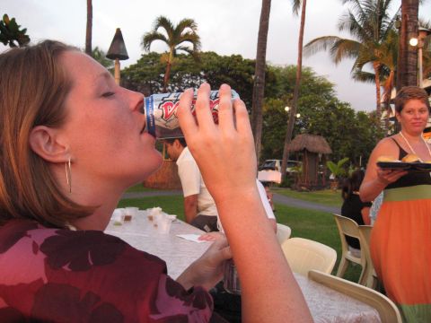 1991 Ford Bronco - A woman drinks from a can while a white vehicle is visible in the background at an outdoor gathering.