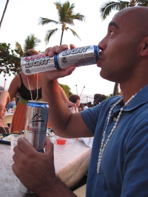 1991 Ford Bronco - A man enjoys a Coors Light beer during an outdoor gathering with palm trees visible.