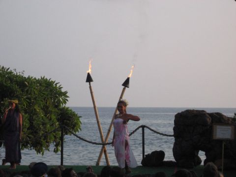 1991 Ford Bronco - A traditional Hawaiian luau features dancers performing with torches against a backdrop of the ocean.
