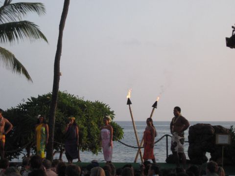 1991 Ford Bronco - A cultural performance takes place on a stage with tiki torches and ocean backdrop.