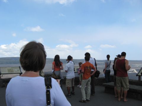 1991 Ford Bronco - Tourists gather to view a scenic overlook, with a wide expanse of land and sky before them.