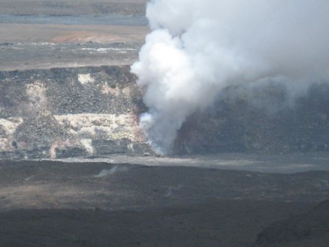1991 Ford Bronco - Steam rises from a volcanic crater, indicating ongoing geological activity.