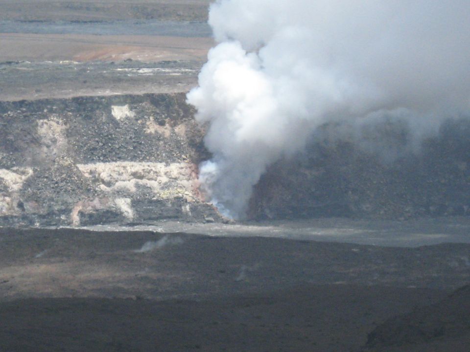 Volcanic crater emitting a large plume of white steam
