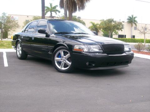 2003 Mercury Marauder - A black 2003 Mercury Marauder is parked in a lot, showing its distinctive grille and chrome wheels.