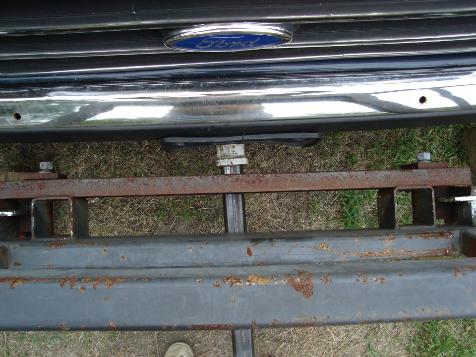 Front bumper and custom hitch receiver assembly of a Ford vehicle.