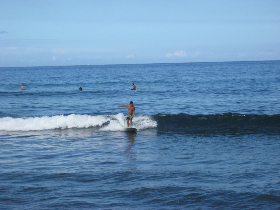Surfer riding a wave in the ocean.