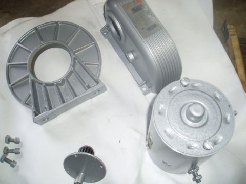 1980 Ford Bronco - Several disassembled parts of a motor, possibly from a 1980 Ford Bronco, are laid out on a white cloth. The parts include a motor housing,…