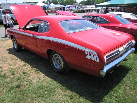 2001 Ford Crown Victoria - Rear view of a red muscle car with racing stripes and a '340' decal, parked outdoors with other vehicles.