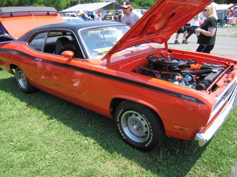 2001 Ford Crown Victoria - Photograph of an orange Plymouth Duster with open hood, not a technical document.