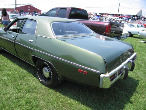 2001 Ford Crown Victoria - Photograph of a green Mopar four-door sedan, not a technical document.