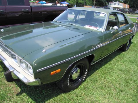 2001 Ford Crown Victoria - Photograph of a green Plymouth four-door sedan, not a technical document.
