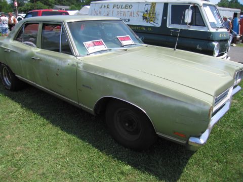2001 Ford Crown Victoria - Photograph of a weathered green Plymouth sedan for sale, not a technical document.