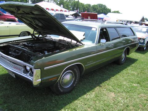 2001 Ford Crown Victoria - A green station wagon is displayed with its hood open, revealing the engine compartment.