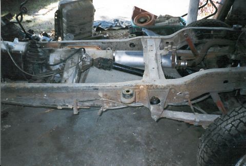 1983 Ford Bronco - The chassis and suspension of a vehicle are shown in this close-up image.