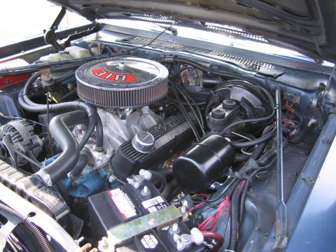 2001 Ford Crown Victoria - Close-up view of a car's engine bay, showing the air filter, valve covers, and battery.