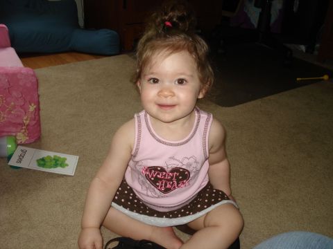 2000 Ford Crown Victoria - A young child sits on a carpeted floor, with a learning flashcard visible to her left.