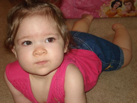 2000 Ford Crown Victoria - A young child is captured in a close-up shot while crawling on a carpeted floor.